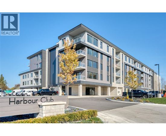 A modern building named Harbour Club is shown with a clear blue sky in the background.