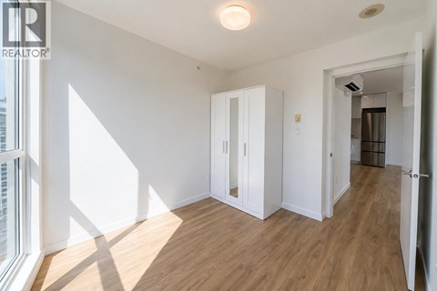 A room with a wooden floor and white walls.
