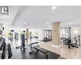 A gym with a variety of equipment including weights and cardio machines.