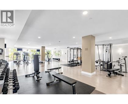 A gym with a variety of equipment including weights and cardio machines.