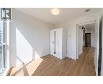 A room with a wooden floor and white walls.