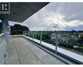 A balcony with a view of houses and trees.