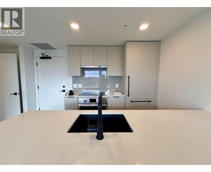 A modern kitchen with a sink and cabinets.