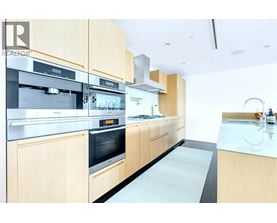 A modern kitchen with wooden cabinets and stainless steel appliances.