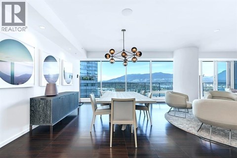 A modern dining room with a view of the city.