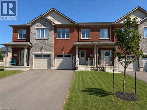 A large, two-story house with a garage and a driveway.