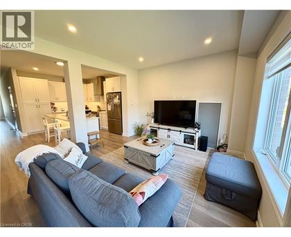 A living room with a grey couch and a television.