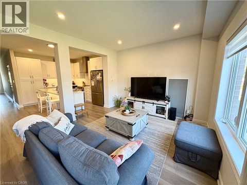 A living room with a grey couch and a television.
