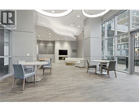 A modern dining room with a TV and a glass wall.