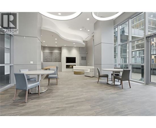 A modern dining room with a TV and a glass wall.