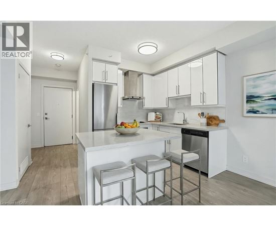 A modern kitchen with white cabinets and a center island.