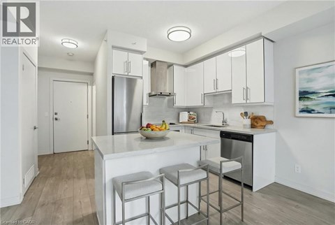 A modern kitchen with white cabinets and a center island.