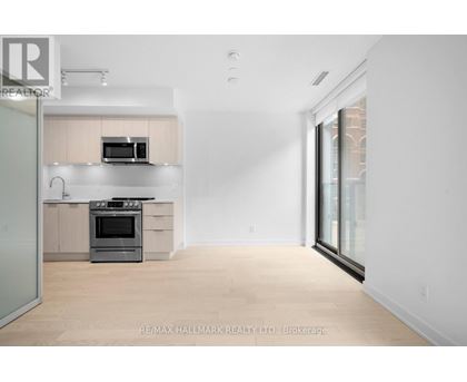 A modern kitchen with a stainless steel oven and microwave.