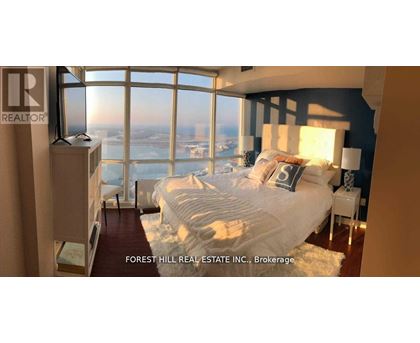 A bedroom with a large bed and a view of the city.