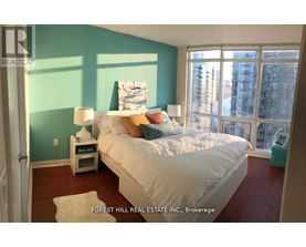 A bedroom with a large bed and a view of the city.