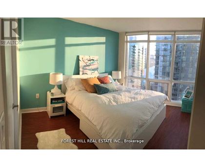 A bedroom with a large bed and a view of the city.