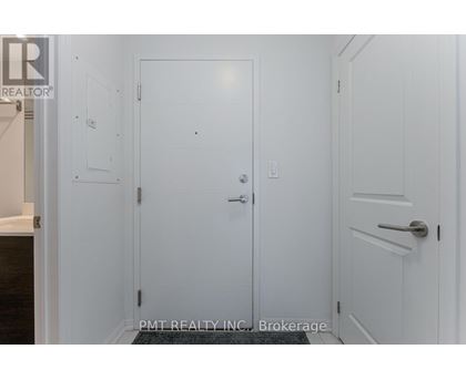 A white door with a handle and a small square on the wall.