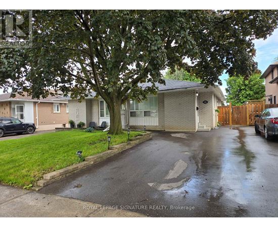 A wet residential street with a Royal LePage Signature Realty Brokerage sign.
