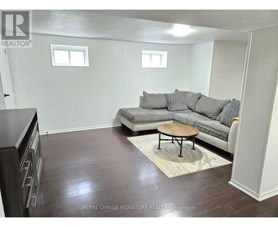 A living room with a grey couch and a wooden coffee table.