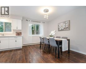 A dining room with a table set for four.