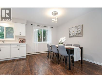 A dining room with a table set for four.