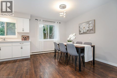 A dining room with a table set for four.