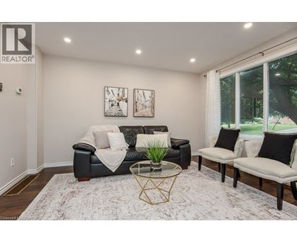 A living room with a black couch and a coffee table.