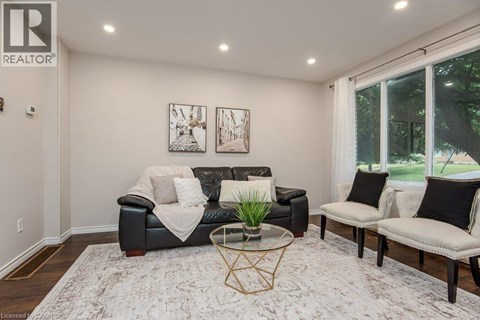 A living room with a black couch and a coffee table.