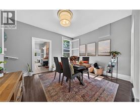 A dining room with a table and chairs.