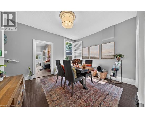 A dining room with a table and chairs.