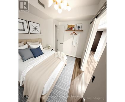 A bedroom with a bed, pillows, a blanket, a coat hanger, and a mirror.