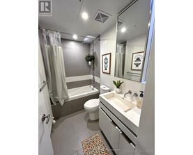 A bathroom with a toilet, sink, and bathtub.