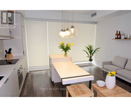 A modern kitchen with a dining table and a couch.