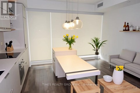 A modern kitchen with a dining table and a couch.