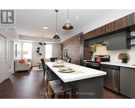 A modern kitchen with a dining table set for two.