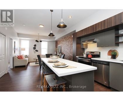 A modern kitchen with a dining table set for two.