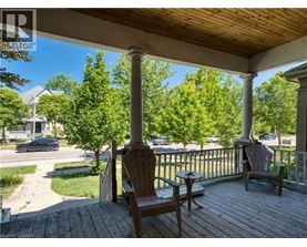 A porch with two chairs and a table.
