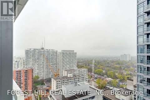 A view of a cityscape from a high-rise building with the text "FOREST HILL REAL ESTATE INC., Brokerage" visible.