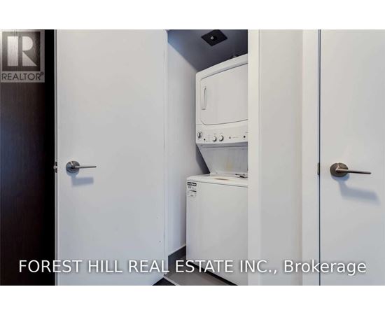 A small white kitchen with a dishwasher and oven.