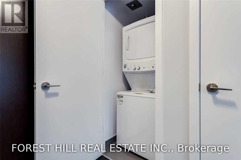 A small white kitchen with a dishwasher and oven.
