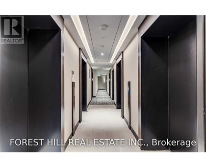 A long hallway with doors on both sides and a carpeted floor.