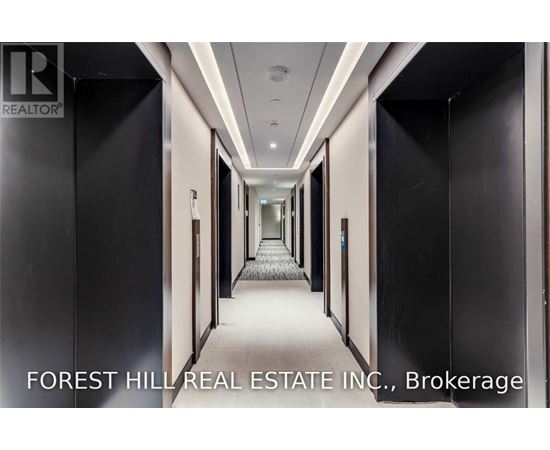 A long hallway with doors on both sides and a carpeted floor.