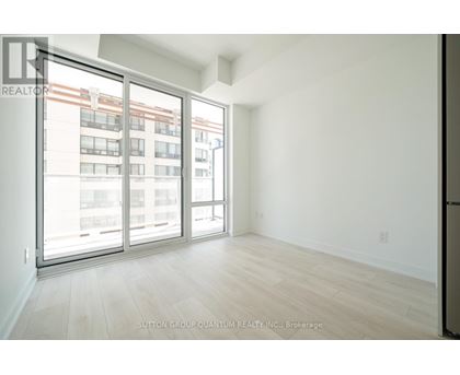 A room with a view of a building through the window.