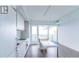 A spacious kitchen with white cabinets and a large island.
