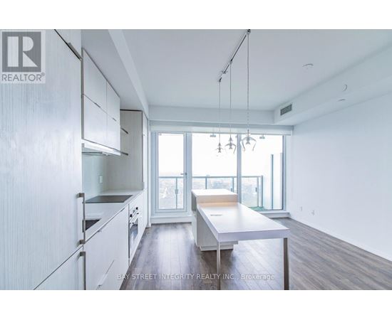 A spacious kitchen with white cabinets and a large island.