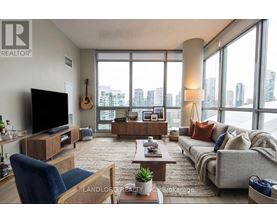 A living room with a large window overlooking a cityscape.