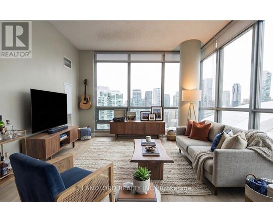 A living room with a large window overlooking a cityscape.