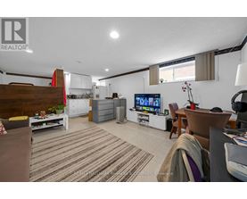 A living room with a TV, a couch, and a dining table.