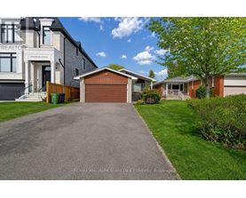 A residential area with houses and a driveway.