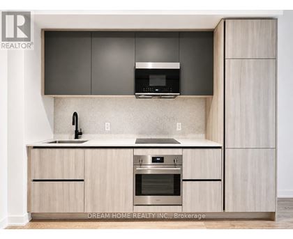 A modern kitchen with wooden cabinets and stainless steel appliances.